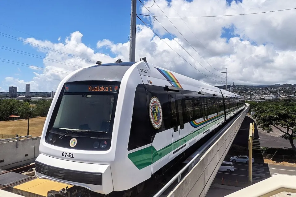 White Honolulu Skyline train on elevated track.